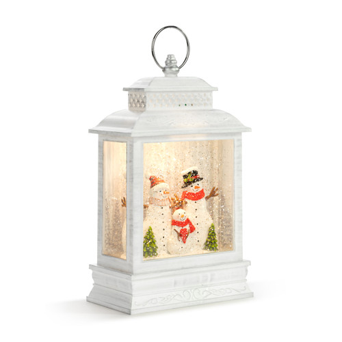 A white lit lantern with a snowman family in a snowy scene inside, displayed angled to the right.