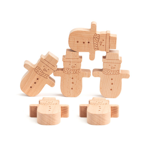 Set of six wood cut snowman shaped blocks used to play a balance game, displayed with several balanced on others.