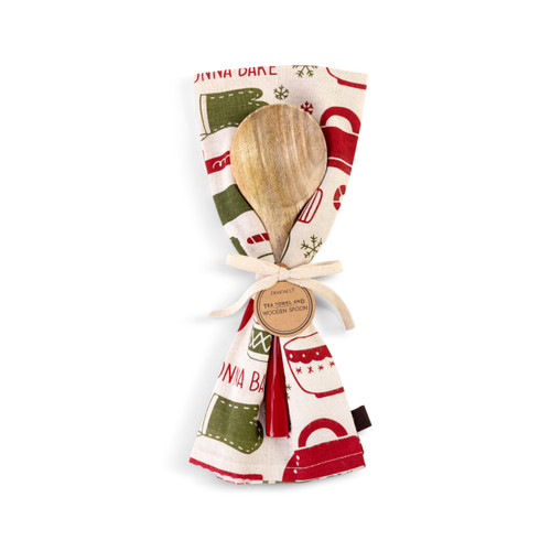 A tan kitchen towel with red and green tools for holiday baking next to a wood spoon with a red handle, displayed tied together with cream ribbon and a product tag.