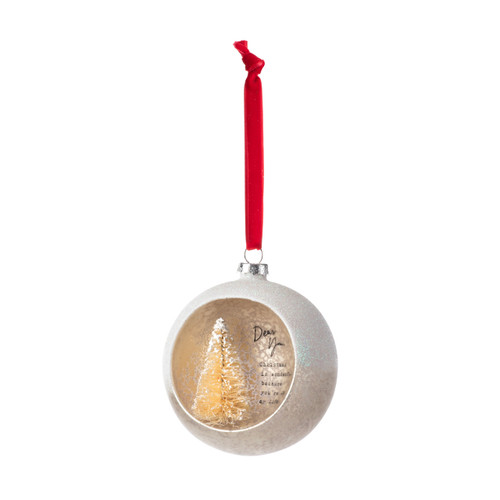 A silver ball ornament on a red ribbon with an opening at the front with a gold tree inside and a sentimental message about you, displayed angled to the left.