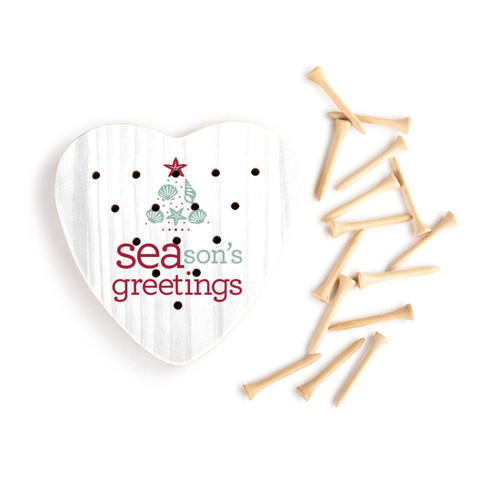 White wood heart shaped peg game that says "SEAsons greetings" with an image of a tree made of seashells. Displayed with the wood pegs out and to the side.