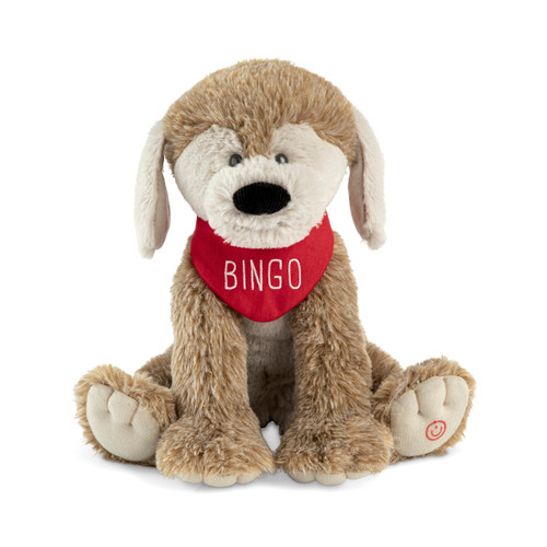 A brown and cream sitting plush dog with a red neckerchief that says "Bingo". He has a button on his foot that will play music.