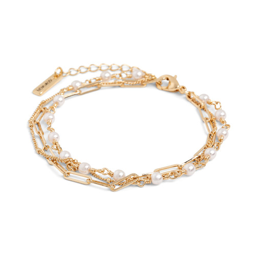 Close up angled view of a multi-strand gold chain adjustable bracelet with small pearls attached to one of the strands.