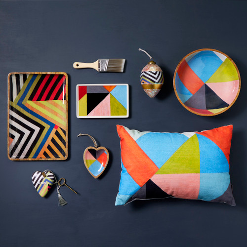 A display of different colorful geometric ArtLifting products such as a pillow, trays, a bowl, ornaments and an Art Heart.