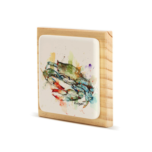 A light wood square block with a cream tile that has a watercolor image of a blue crab, displayed angled to the left.