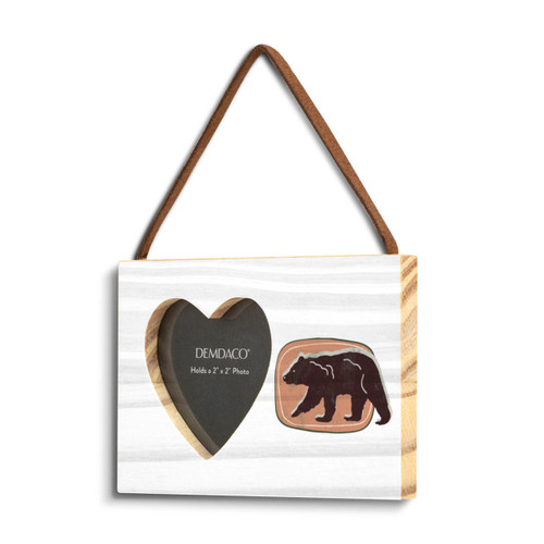 A rectangular hanging white wood frame ornament with a graphic image of a walking bear on a peach background and a 2x2 heart shaped opening for a photo, displayed angled to the left.