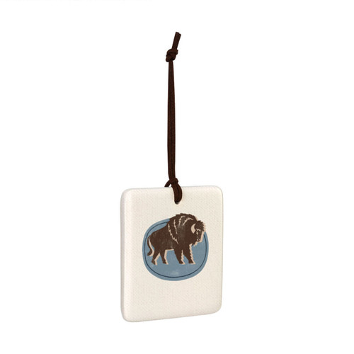 A square hanging tile ornament with a graphic image of a walking buffalo on a blue background, displayed angled to the right.