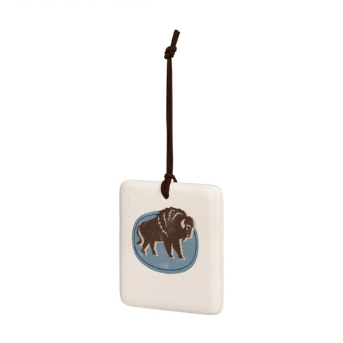 A square hanging tile ornament with a graphic image of a walking buffalo on a blue background, displayed angled to the left.
