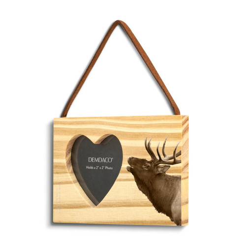 A rectangular wood hanging ornament with a heart shaped 2 inch photo opening next to an image of an elk, displayed angled to the left.