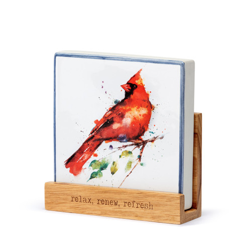 A square oil diffuser with a watercolor image of a red cardinal on it set in a wood stand that says "relax, renew, refresh", displayed angled to the left.