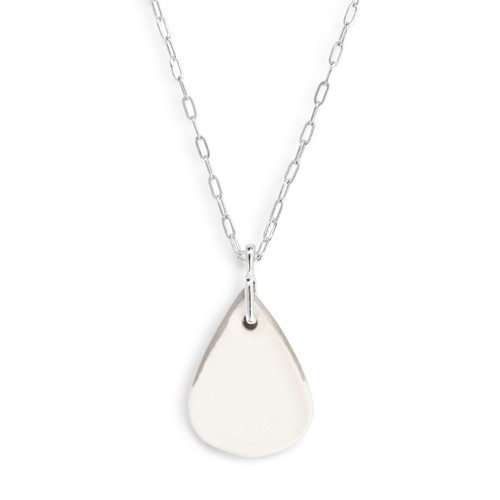 Detail view of the backside of the charm on an adjustable silver chain necklace with a teardrop shaped gray and white diffuser charm.