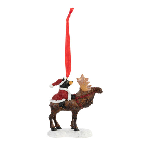 Right profile view of a Christmas ornament figurine of a standing moose with a small black bear dressed as Santa on his back.