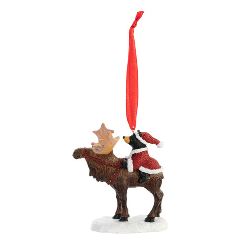 Left profile view of a Christmas ornament figurine of a standing moose with a small black bear dressed as Santa on his back.