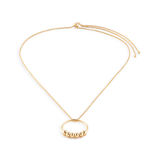 An adjustable gold chain necklace with a round gold charm with six gold beads on it that move around, displayed at an angle to show depth.