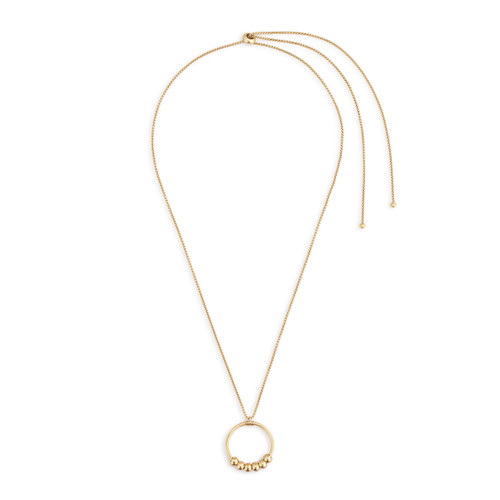 An adjustable gold chain necklace with a round gold charm with six gold beads on it that move around.