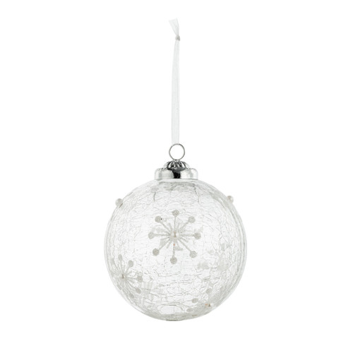 A hanging white glass ornament decorated with snowflakes.