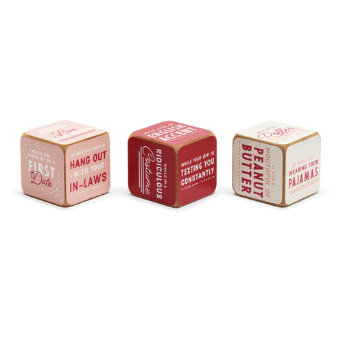 A set of three wood dice with red, white and pink backgrounds and text asking different scenario questions when rolled together.