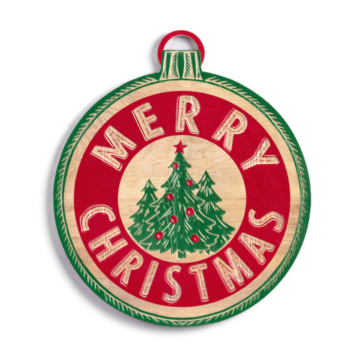 A round wood holiday door hanger with three green trees in the center and Merry Christmas in a band of red with a thin green border on the edge that looks like an ornament.