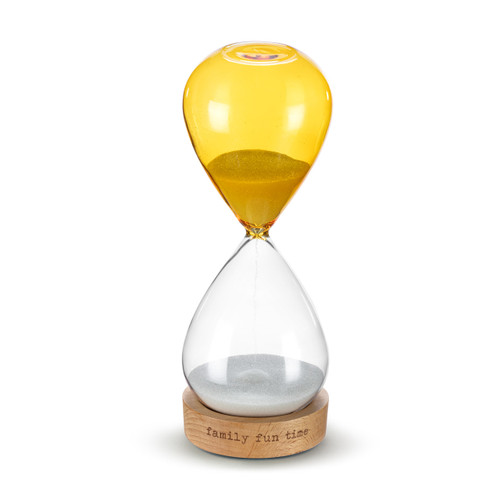 A glass sand timer with yellow glass on the bottom half sitting in a wood base that reads "family fun time", displayed with the clear glass on the bottom and the yellow on top.