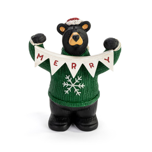 A sculpted figurine of a black bear wearing a green and white snowflake sweater, a Santa hat and holding a white garland that says "Merry".