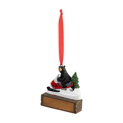 An ornament of a black bear riding on a snow machine, hanging from a red ribbon. There is a spot in front for customization, displayed angled to the left.