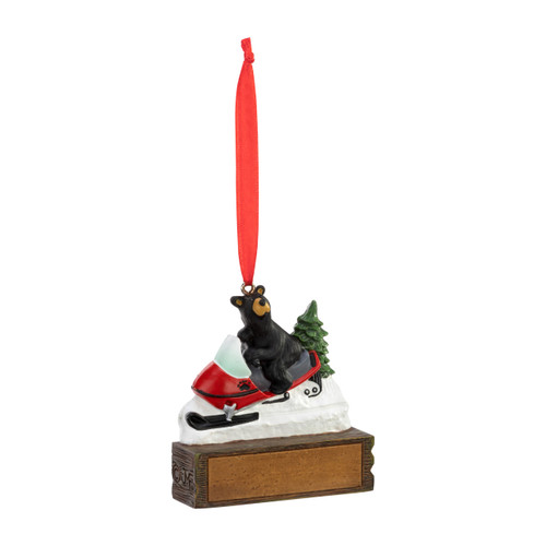 An ornament of a black bear riding on a snow machine, hanging from a red ribbon. There is a spot in front for customization, displayed angled to the right.