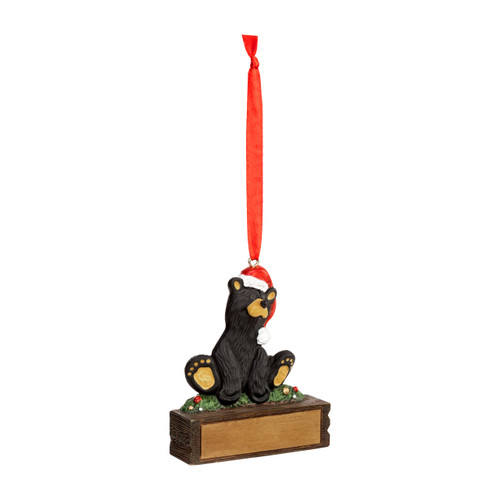 A hanging ornament that has a black bear in a Santa hat on a rectangular base that can be personalized, displayed angled to the right.
