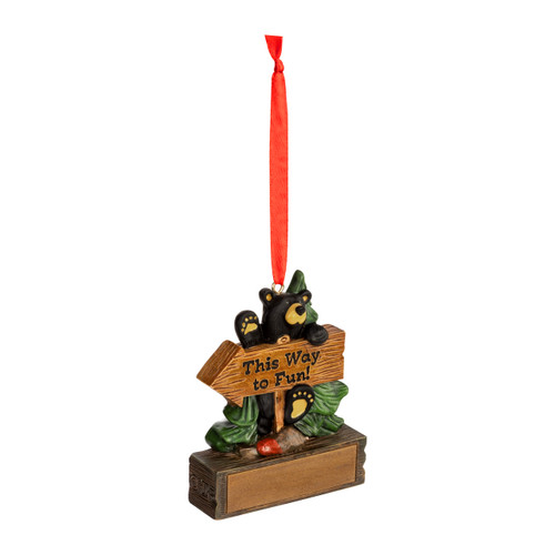 A hanging ornament with a black bear behind a sign that says "This Way to Fun" on a rectangular base that can be personalized, displayed angled to the right.