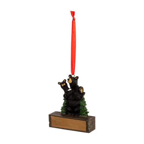 A hanging ornament with one black bear holding another in front of pine trees on a rectangular base that can be personalized, displayed angled to the left.