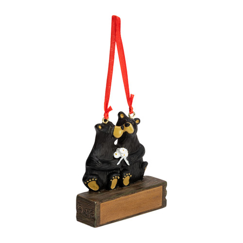 A hanging ornament with two black bears kissing on a rectangular base that can be personalized, displayed angled to the right.