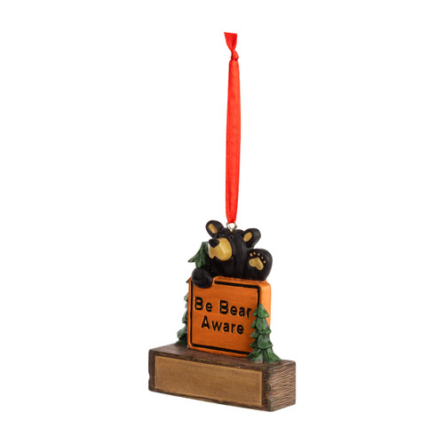 A hanging ornament with a black bear behind a sign that says "Be Bear Aware" on a rectangular base that can be personalized, displayed angled to the left.