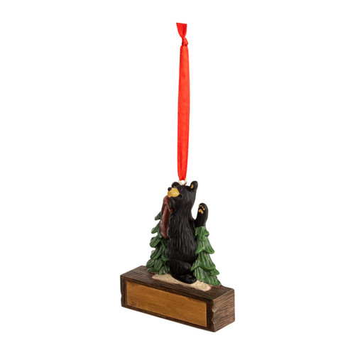 A hanging ornament with a black bear hiking on a rectangular base that can be personalized, displayed angled to the left.