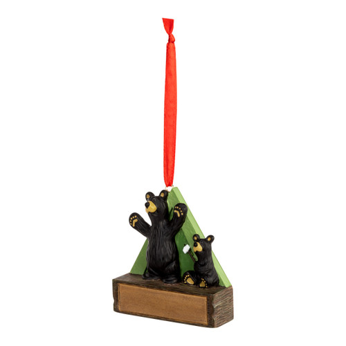 A hanging ornament with two black bears in front of a green tent on a rectangular base that can be personalized, displayed angled to the left.