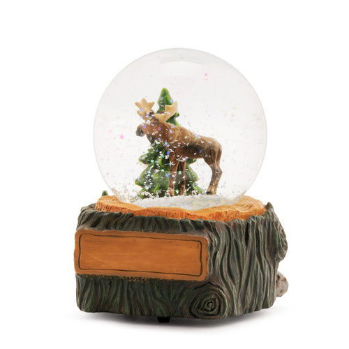 A glass snow globe with a moose and pine tree inside. The base is sculpted like a tree trunk and has a rectangle on the front for personalization, displayed angled to the left.