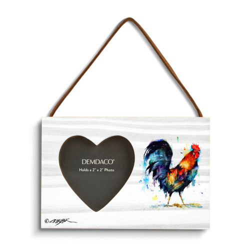 A rectangular wood hanging frame with a heart shaped 2 inch photo opening next to a watercolor image of a rooster.