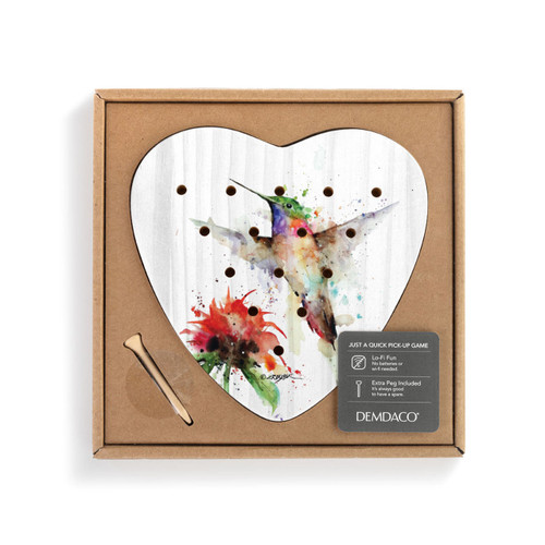 A white wood heart shaped peg game with a watercolor image of a hummingbird and red flower, displayed in a packaging box.