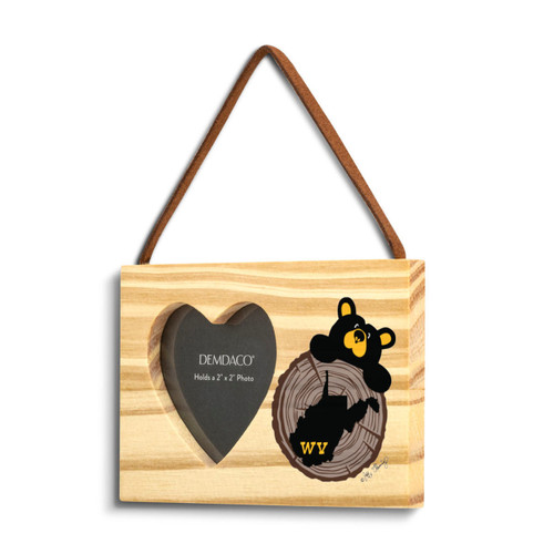 A rectangular wood hanging ornament with a 2x2 inch heart shaped photo opening next to an image of a black bear peeking over a wood stump with West Virginia on it, displayed angled to the left.