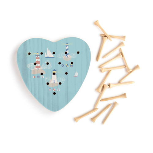 A blue wood heart shaped peg game with an illustration of lighthouses and sailboats, displayed with the wood pegs out and to the side.