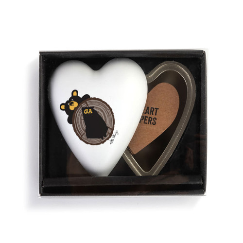 Heart shaped keeper with the image of a black bear peeking over a tree stump with Georgia on it, with the lid offset to the base, displayed in a packaging box.