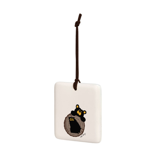 A square cream hanging tile magnet ornament with an illustration of a black bear peeking over a wood stump with the state of Georgia on it, displayed angled to the left.
