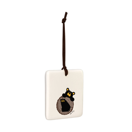 A square cream hanging tile magnet ornament with an illustration of a black bear peeking over a wood stump with the state of Georgia on it, displayed angled to the right.