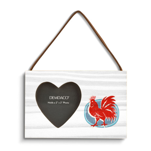 A rectangular wood hanging frame with a heart shaped 2 inch photo opening next to an illustration of a red rooster on a blue background.