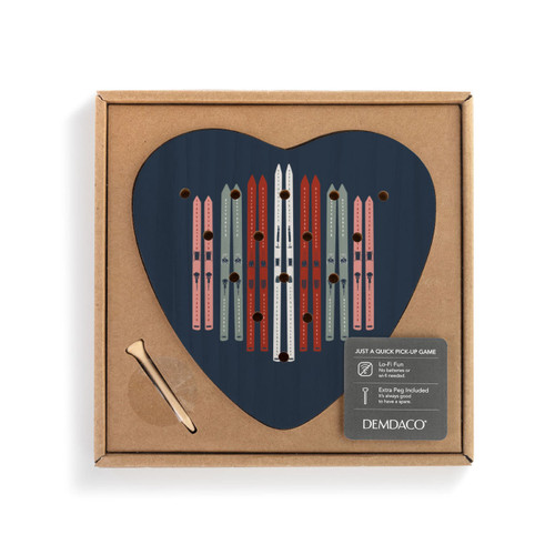 A dark blue wood heart shaped peg game with an illustration of different colored pairs of skis, displayed in a packaging box.
