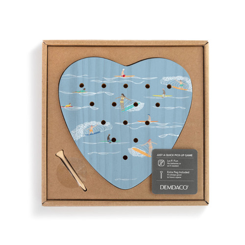 A blue wood heart shaped peg game with an illustration of surfers on the water, displayed in a packaging box.
