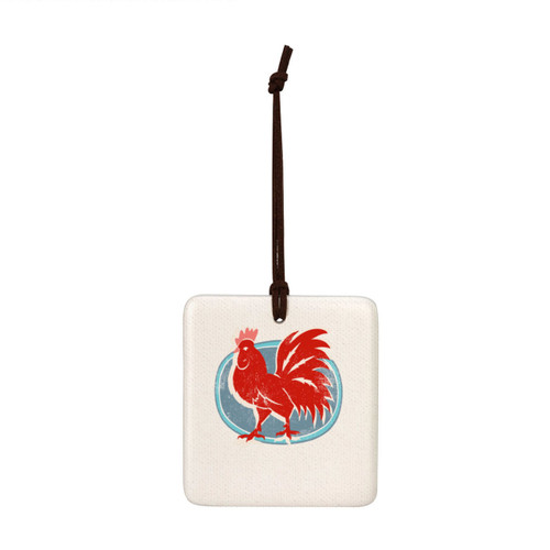 A square white tile hanging magnet ornament with a red rooster on a blue background.
