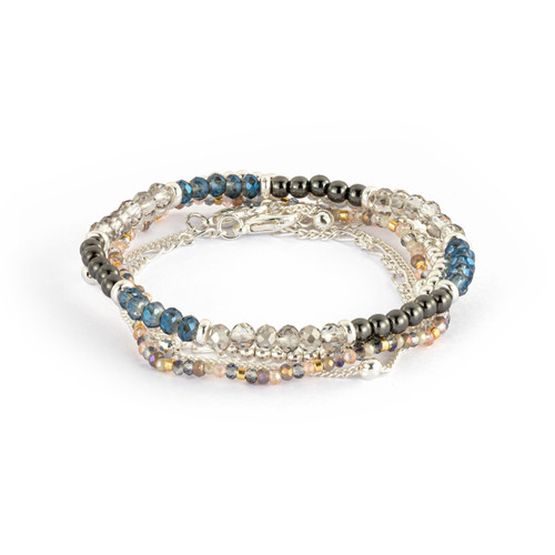 A multi-strand bracelet made with beads and silver chain. The beads are primarily in shades of gray and blue, displayed at a low angle to show depth.