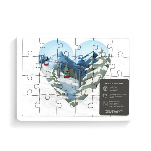 A 24 piece postcard puzzle with a heart shaped graphic image of a ski lift and snowy mountainside, displayed with a product sticker attached.