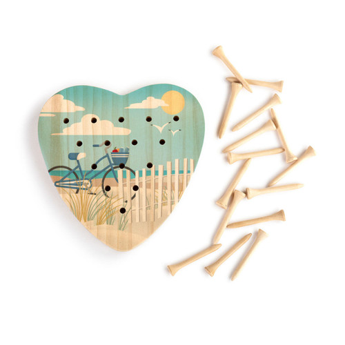 A wood heart shaped peg game with graphic artwork of a bicycle and white fence at the beach, displayed with the wood pegs out and to the side.