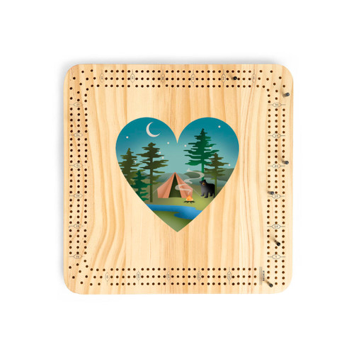 A light wood cribbage board game with heart shaped graphic artwork of a wooded campsite and a curious bear in the middle.