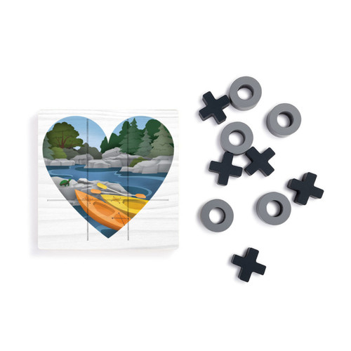 A square white wood board for tic tac toe with heart shaped graphic artwork of kayaks at a rivers edge, displayed next to a set of X's and O's in gray and black.